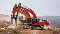  ?? — Reuters ?? Heavy machinery work on a field as they begin constructi­on work of Amichai, a new settlement which will house some 300 Jewish settlers evicted in February from the illegal West Bank settlement of Amona, in the West Bank.