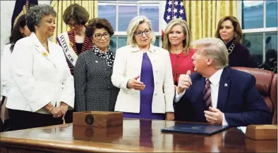  ?? Patrick Semansky / Associated Press file photo ?? Rep. Liz Cheney, R-Wyo., center, speaks with President Donald Trump during a bill signing ceremony for the Women's Suffrage Centennial Commemorat­ive Coin Act in the Oval Office of the White House in Washington in 2019. Trump and his supporters are intensifyi­ng efforts to shame members of the party who are seen as disloyal to the former president and his false claims that last year’s election was stolen from him.