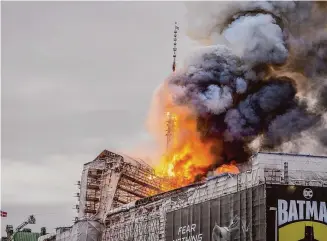  ?? Ida Marie Odgaard/Associated Press ?? Fire rages from the dragon spire of the Old Stock Exchange in Copenhagen, Denmark on Tuesday, causing the collapse of the iconic spire of the 17th-century Old Stock Exchange as passersby rushed to help emergency services save priceless paintings and other valuables.