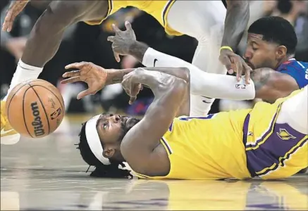  ?? LAKERS GUARD Wally Skalij Los Angeles Times ?? Patrick Beverley, foreground, and Clippers guard Paul George battle for a loose ball during their game in October.