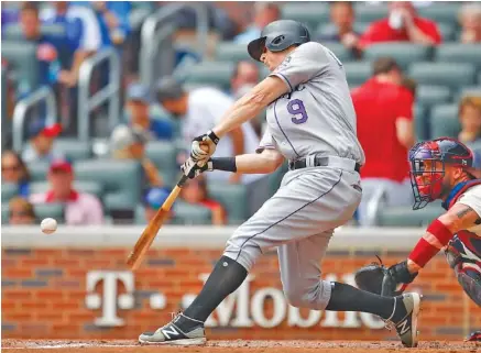  ?? THE ASSOCIATED PRESS ?? The Colorado Rockies’ D.J. LeMahieu hits a home run off Atlanta Braves starter Anibal Sanchez in the third inning of Sunday’s game at SunTrust Park. LeMahieu’s homer made it 2-1 and gave the visiting Rockies the lead for good as they went on to win 4-2.