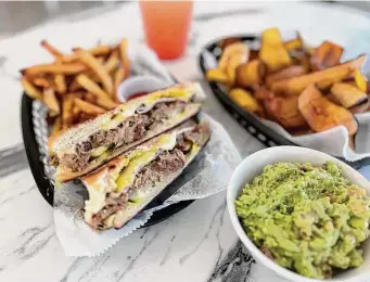  ?? Photos by Mike Sutter/Staff ?? Bilia Eatery: The Cuban sandwich, guava limeade, plantain chips and guacamole offer just a glimpse of the menu of Cuban, Mexican and South American dishes.