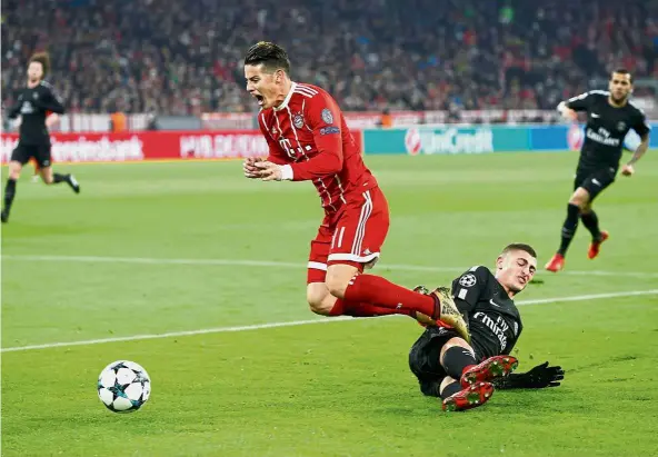  ?? — Reuters ?? Halted: Bayern Munich’s James Rodriguez going airborne after a tackle by Paris St Germain’s Marco Verratti at the Allianz Arena on Tuesday.