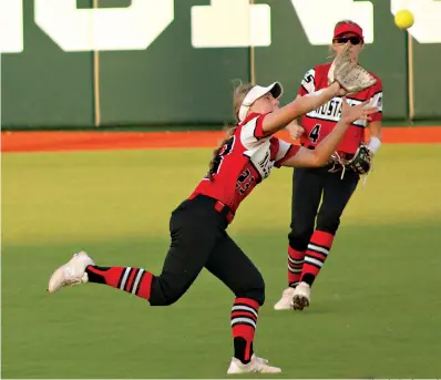  ?? Photo by Travis Harsch ?? ■ Hughes Springs’ centerfiel­der Peyton Blythe makes a running catch as Pearl Perry backs her up in the Class 3A state championsh­ip game against Santa Gertrudis Academy on Thursday in Austin. The Lady Mustangs fell, 8-3, but had a season for the ages.