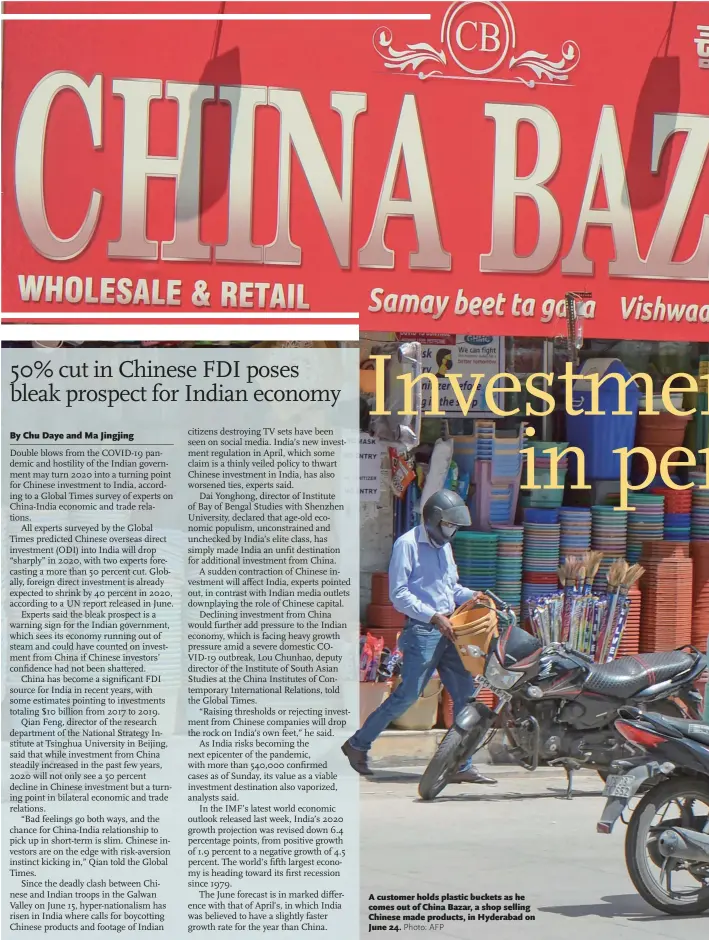  ?? Photo: AFP ?? A customer holds plastic buckets as he comes out of China Bazar, a shop selling Chinese made products, in Hyderabad on June 24.