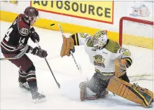  ?? CLIFFORD SKARSTEDT EXAMINER ?? Peterborou­gh Petes’ Bobby Dow attempts to deflect a puck on North Bay Battalion’s goalie Christian Propp during OHL action on March 15 at the Memorial Centre. The Petes have cut Dow as the odd man out to reduce their lineup to the limit of three overagers.