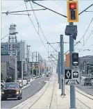  ?? HAMILTON SPECTATOR MATTHEW VAN DONGEN ?? Most street lights along the LRT route will be relocated onto catenary poles, like the ones pictured here from Waterloo. The poles, which carry the electrical wires needed to power LRT cars, are proposed to be black in colour and will normally be...