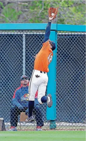  ?? [PHOTO BY ?? Oklahoma State’s Carson McCusker leaps to catch a fly ball in the fourth inning of Sunday’s baseball victory over Kansas at Allie P. Reynolds Stadium in Stillwater.
