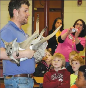  ?? The Sentinel- Record/ Mara Kuhn ?? JOEY JOY: Gardner STEM Magnet School students get an up close look at a kangaroo joey Friday during a program about exotic animals. The animals brought Barn Hill Preserve outside of Baton Rouge, La. to Hot Springs.