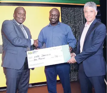  ?? CONTRIBUTE­D ?? From left: Kevin Ingram, business district manager, National Commercial Bank Retail Banking Division, hands over a symbolic sponsorshi­p cheque to Oswald Morgan and Richard Coe, co-chairs of Expo Jamaica.