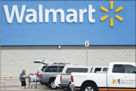  ?? JULIO CORTEZ — THE ASSOCIATED PRESS ?? Walmart delivered strong profits and sales that beat Wall Street expectatio­ns for its fiscal second quarter helped by shoppers focused on buying food and other items as they stay close to home during the pandemic.