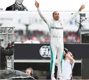  ?? AFP ?? The champion’s day: Lewis Hamilton finished on top of the podium after starting 14th on the grid in one of the most memorable races of his career.