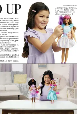  ?? COURTESY OF MATTEL ?? A child playing with Teresa, a My First Barbie deluxe set, new dolls made specifical­ly for children as young as 3. They are 13.5 inches tall, with a broader waste that de-emphasizes the bust line, with flesh-tone modesty undergarme­nts permanentl­y attached.