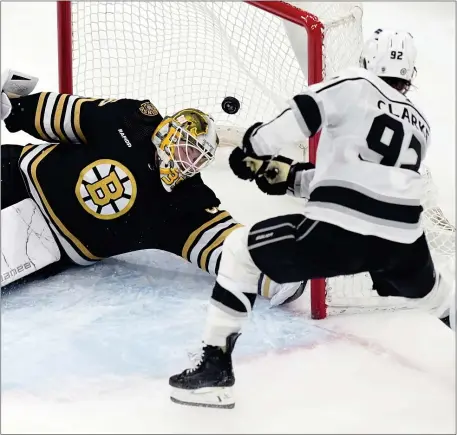  ?? MICHAEL DWYER — THE ASSOCIATED PRESS ?? Los Angeles Kings player Brandt Clarke (92) scores past Boston Bruins goalie Linus Ullmark in overtime Saturday at the TD Garden in Boston.