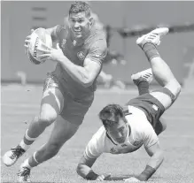  ?? AP ?? Canada’s Justin Douglas, left, runs past Japan’s Dai Ozawa to score on the way to a 35-17 victory during the Rugby Sevens World Cup consolatio­n round in San Francisco on Saturday.