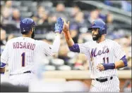  ?? Elsa / Getty Images ?? New Met Jose Bautista, right, celebrates his run with teammate Amed Rosario in the second inning against the Marlins on Tuesday in New York.
