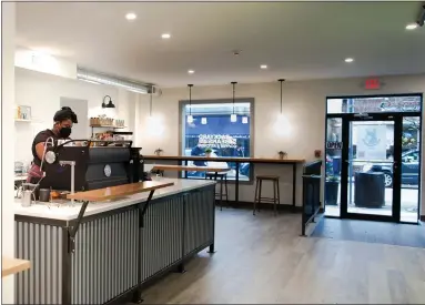  ?? PHOTO COURTESY BACKYARD BEANS COFFEE COMPANY ?? An employee, donning a mask, stands inside the new Backyard Beans Coffee Company’s Ambler location at 22 E. Butler Ave. in downtown Ambler.