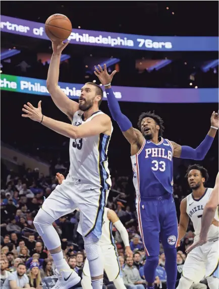  ??  ?? The Grizzlies' Marc Gasol shoots in front of the 76ers' Robert Covington during the first half of Wednesday’s game in Philadelph­ia. MATT SLOCUM/AP