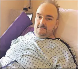  ?? SUEANN MUSICK/THE NEWS ?? Kent Corbett is shown in his hospital bed during his recovery from surgery. Corbett is well known in the county for his volunteer efforts and a fundraiser has been planned for April 29 to help with some of the financial costs he will be facing in the...