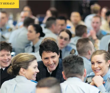  ?? MICHAEL BELL / THE CANADIAN PRESS ?? Prime Minister Justin Trudeau, seen with RCMP cadets in Regina, is reportedly looking for a qualified woman to lead the troubled police force.