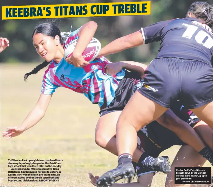  ?? Picture: GLENN HAMPSON ?? Keebra Park’s Paige Nikora is brought down by the Marsden defence in the Titans Cup open girls grand final.
