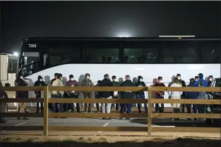  ?? ELI HARTMAN — VIA THE ASSOCIATED PRESS ?? Migrant children and teenagers are processed after entering the site of a temporary holding facility south of Midland, Texas, on Sunday. Migration flows to the U.S. from Mexico are surging again.