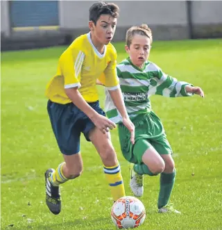  ??  ?? Ferry (yellow) beat Celtic in the U/15 George Taylor League at Dawson Park.