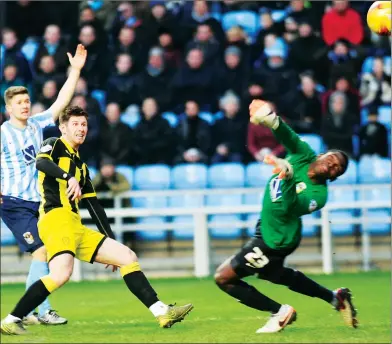  ??  ?? ON THEIR WAY: Calum Butcher chips the ball past Reice Charles-Cook to score the Brewers’ first