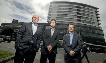  ?? ROBERT KITCHIN/STUFF ?? Cornerston­e Partners has recently bought four commercial floors in the Trade Me building (pictured) in central Wellington. From left, part-owner and chief executive Andrew Cotterrell, 50 per cent owner and director Charlie Zheng, and chief financial officer and director John Yiappos.