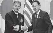  ?? KYODO NEWS Sipa USA ?? Japanese Prime Minister Fumio Kishida, right, shakes hands with Admiral John Aquilino, commander of the U.S. Indo-pacific Command, in Tokyo on Monday.