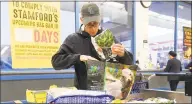  ?? Matthew Brown / Hearst Connecticu­t Media ?? Mark Feiner, of Greenwich, bags his own groceries using recyclable bags after shopping at Shop Rite on Apr. 20 in Stamford. Stamford enacted a plastic bag ban on May 3 and state residents have until July 1, 2021 to convert to using reusable shopping bags before plastic bags are banned under legislatio­n passed this session.