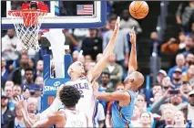  ?? (AP) ?? Oklahoma City Thunder guard Chris Paul (right), shoots as Philadelph­ia 76ers forward Tobias Harris (back left), defends during the second half of
an NBA basketball game on Nov 15 in Oklahoma City.