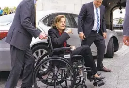  ?? J. SCOTT APPLEWHITE AP FILE ?? Sen. Dianne Feinstein, D-San Francisco, is assisted to a wheelchair by staff as she returns to the Senate at the Capitol in Washington on May 10.