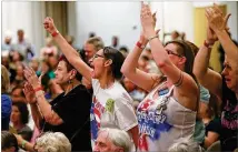  ?? CURTIS COMPTON / CCOMPTON@AJC.COM ?? Opponents react while Sen. Johnny Isakson holds his town hall meeting at Kennesaw State University on Monday. Isakson was booed during his remarks about police brutality.
