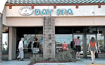  ?? JOE RAEDLE/GETTY ?? People mill around Orchids of Asia Day Spa, which NFL owner Robert Kraft allegedly frequented, in Jupiter, Fla.