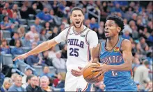  ?? [BRYAN TERRY/ THE OKLAHOMAN] ?? Oklahoma City's Shai Gilgeous-Alexander (2) goes past Philadelph­ia's Ben Simmons (25) during Friday's overtime win at Chesapeake Energy Arena.