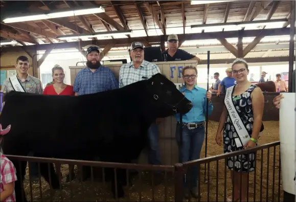  ?? PHOTOS BY ALIAH KIMBRO — THE MORNING JOURNAL ?? Daisy Bockmore poses with Lorain County Fair King and Queen along with auction winner T.L. Keller Meats.