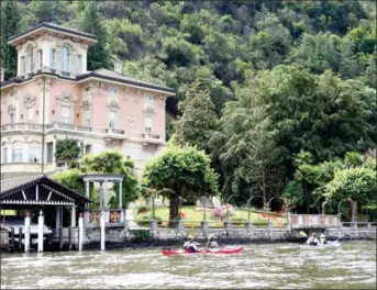  ?? DINA MISHEV/THE WASHINGTON POST ?? A group from Tofino Expedition­s kayak past a villa on Lake Lugano; most of the villas on the lake are best seen from the water. In 1925, Alfred Hitchcock shot some of his film on the lake. When Winston Churchill vacationed at neighbouri­ng Lake Como...