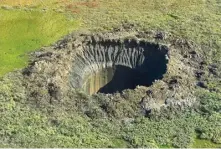  ?? ?? Scientists say they don’t know why these Siberian blast craters are appearing in only a small area of the Arctic. Photo: Vasily Bogoyavlen­sky