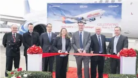  ??  ?? &gt;Jet2.com chief Steve Heapy cuts the ribbon on the 100th aircraft