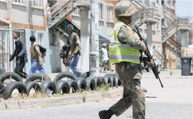  ?? PICTURE: HENK KRUGER ?? ON PATROL: Soldiers were previously deployed in spots across Lavender Hill. The SANDF says it is ‘ready and waiting’ for orders to enter gang-ravaged communitie­s.