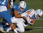  ?? JOHN LOCHER — THE ASSOCIATED PRESS ?? San Jose State defensive lineman Cade Hall (92) sacks Boise State quarterbac­k Hank Bachmeier (19) during the Mountain West championsh­ip in December.