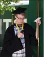  ?? ?? Joseph Blakemore of Littleton, who was getting a bachelor’s in business, waits for the processon to start.