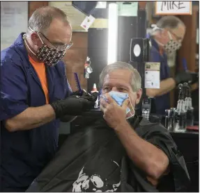  ?? More photos at arkansason­line.com/57hair/. (Arkansas Democrat-Gazette/Staton Breidentha­l) ?? Mike Jackman, owner of Jerry’s Barbershop in Little Rock’s Heights neighborho­od, gives Mark Polevoy a haircut Wednesday as both take precaution­s against the coronaviru­s. Jackman said his staff “was all aboard” for reopening under state guidelines for barbers, hair salons, tattoo parlors, nail salons and medical spas.