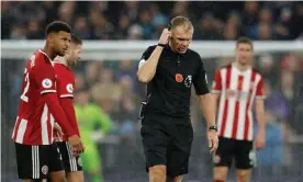  ??  ?? Graham Scott receives the VAR decision to disallow a goal scored by Sheffield United’s David McGoldrick against Tottenham on Saturday. Photograph: Peter Nicholls/Reuters