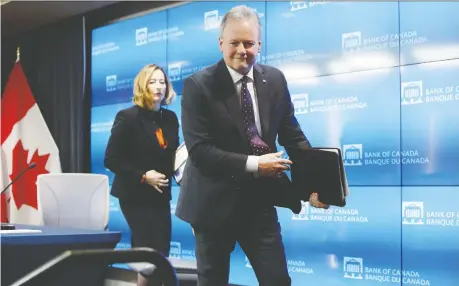  ?? DAVID KAWAI/BLOOMBERG ?? Stephen Poloz, Bank of Canada governor, right, and Carolyn Wilkins, senior deputy governor, leave following a news conference in Ottawa on Wednesday. Economists expect the central bank will have good reasons to slash interest rates given the economic slowdown.