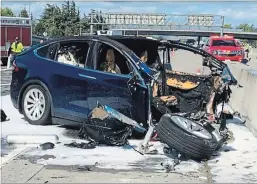  ?? KTVU VIA THE ASSOCIATED PRESS ?? Emergency personnel work a the scene where a Tesla electric SUV crashed into a barrier on U.S. Hwy. 101 in Mountain View, Calif., on March 23. The driver was killed.