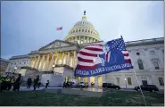  ?? MANUEL BALCE CENETA — THE ASSOCIATED PRESS ?? Trump supporters leave a flag outside the Capitol on Wednesday evening.