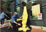  ?? Erik Trautmann / Hearst Connecticu­t Media ?? Sculptor Michael Alfano adjusts his sculpture outside a vacant storefront as the SoNo Arts Festival introduces their first-ever Gallery Walk along Washington Street Historic District Saturday in South Norwalk.