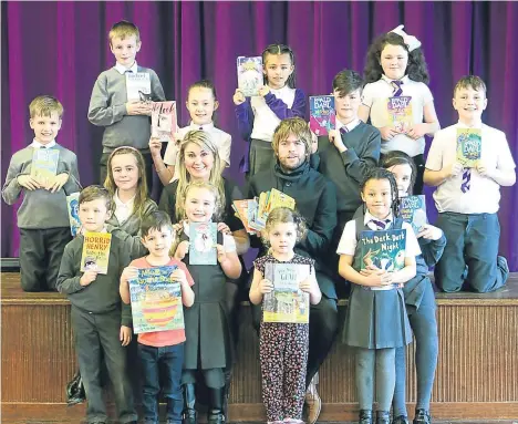  ??  ?? PUPILS at St Pius Primary got a late World Book Day treat courtesy of a local taxi firm.
City Cabs owner Lee Jack was on hand to give every child a book courtesy of the firm.
World Book Day, which is celebrated on the March 1, was delayed at the...